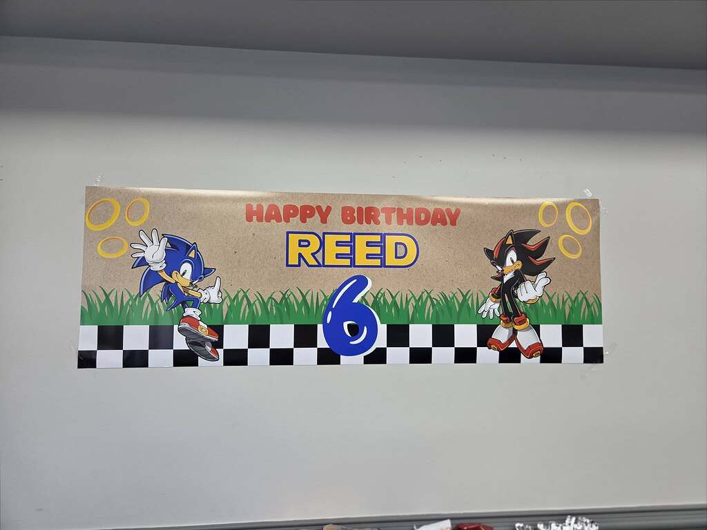 Custom Sonic the Hedgehog themed birthday banner that reads Happy Birthday Reed with a prominent blue number six.