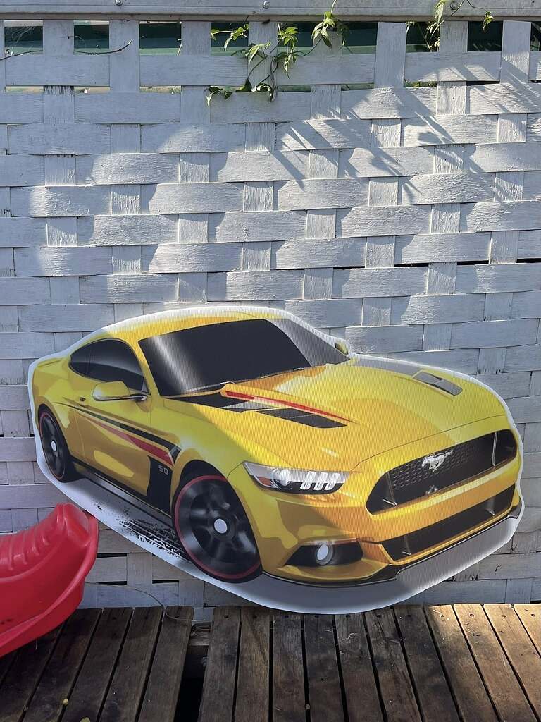 Yellow Ford Mustang sports car cutout display.