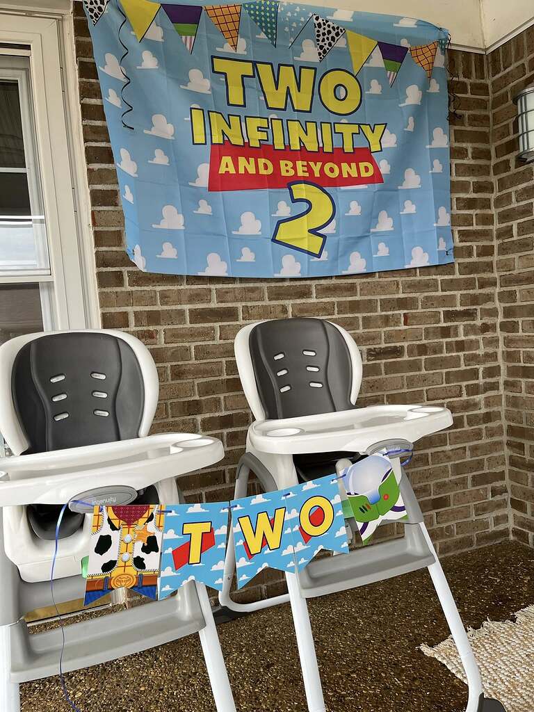 Toy Story inspired Two Infinity and Beyond 2nd birthday party banner with matching high chair decorations.