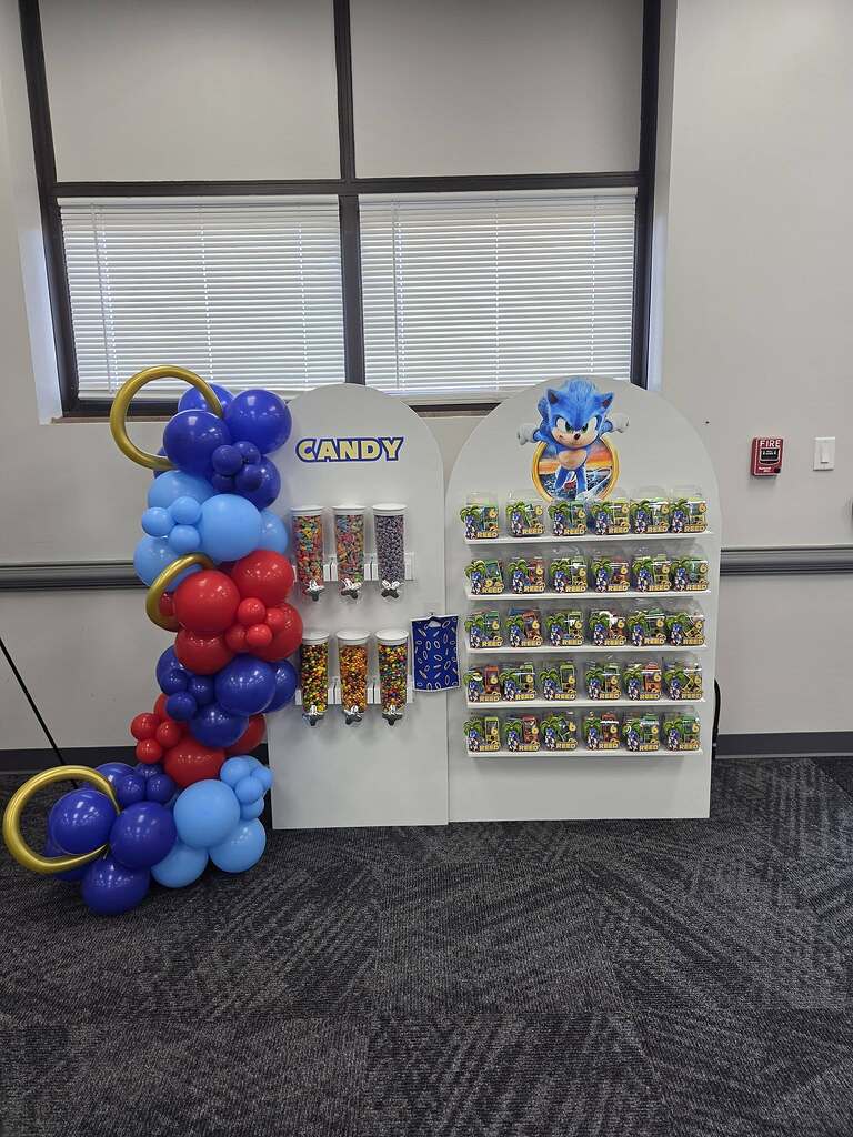 Sonic the Hedgehog themed party favor rack with candy dispensers and customized treats.