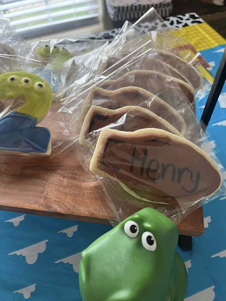Toy Story inspired decorated sugar cookies, including a number two cookie and cookies personalized with Henry.