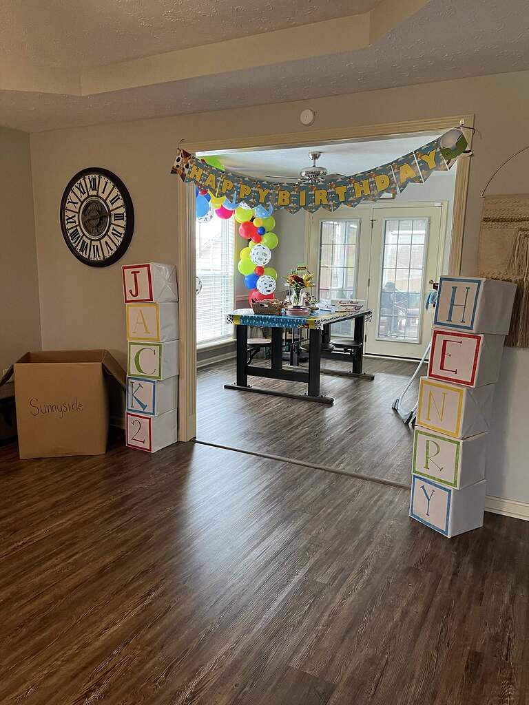 Toy Story inspired birthday party decorations with letter blocks spelling Jack and Henry