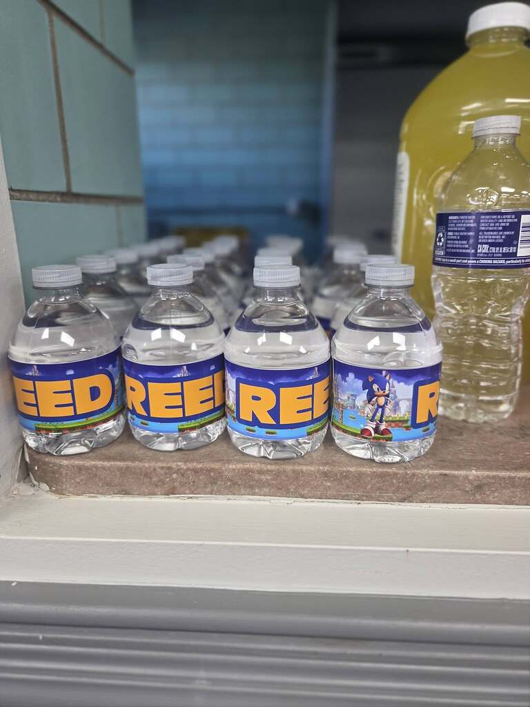 Row of small water bottles featuring Sonic the Hedgehog labels with the word SPEED on the front.
