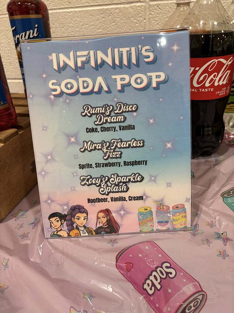 Infiniti's Soda Pop menu board listing Rumi's Disco Dream, Mira's Fearless Fizz, and Zoey's Sparkle Splash flavors.