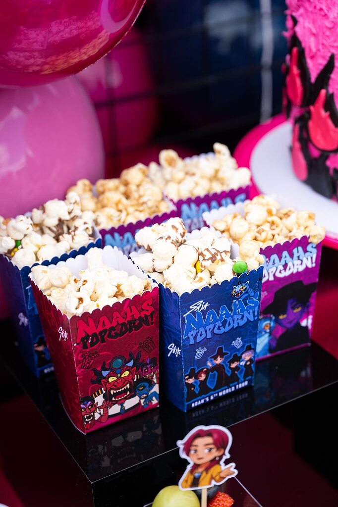 Popcorn boxes branded with custom Naahs Popcorn graphics for a themed event.