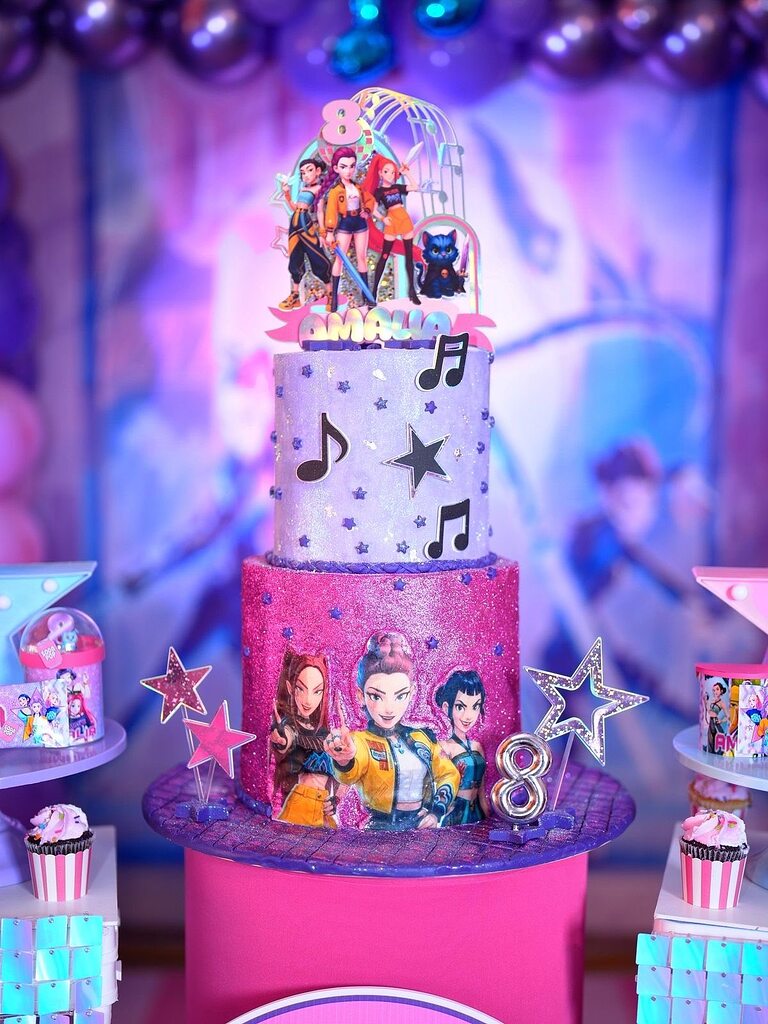Two-tier glittery birthday cake with K-pop inspired theme, music note decorations, and a custom number 8 topper.