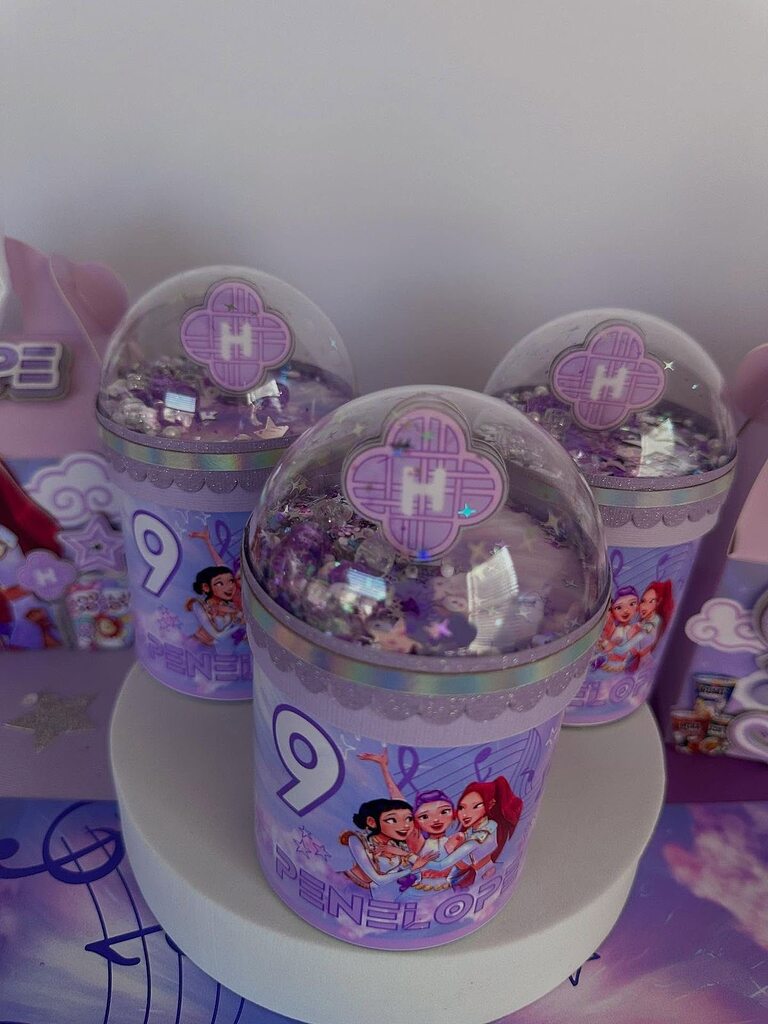 Set of custom purple personalized party favor shakers with character illustrations and number nine for a birthday.